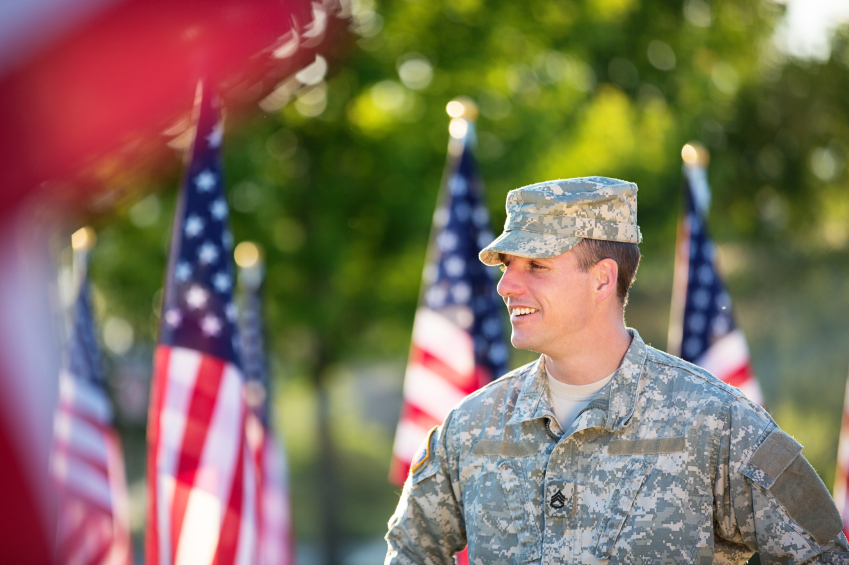 Male veteran standing among flags