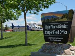 The High Plains District sign with a Wyoming air rescue helicopter parked in the background.