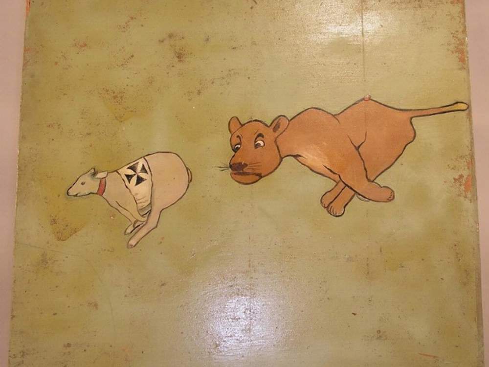 Military insignia art featuring a cat chasing a dog.