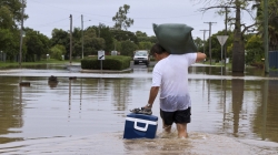 Man walking in flood waters.