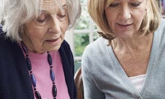 Older woman and her daughter going over long term care  finances