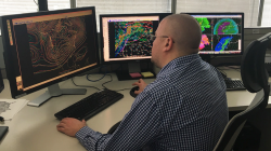 National Weather Service  meteorologist Andrew Orrison uses weather model data to generate precipitation forecasts from NOAA's Weather Prediction Center in College Park, Maryland. 