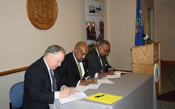 USDA Rural Development State Director signs the Subsidy Layering Review MOU agreement with WHEDA Executive Director and HUD Midwest Regional Administrator in Madison, Wisconsin