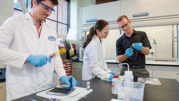 Argonne scientists Jason Croy, Manar Ishwait and Michael Murphy assemble lithium-ion battery electrodes for testing. (Image by Mark Lopez / Argonne National Laboratory.)