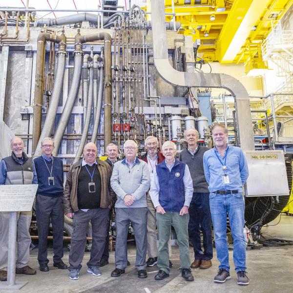 Retired physicists who worked on TFTR in front of a neutral beam box in the TFTR test cell in 2019. (Photo by Elle Starkman/Office of Communications.)