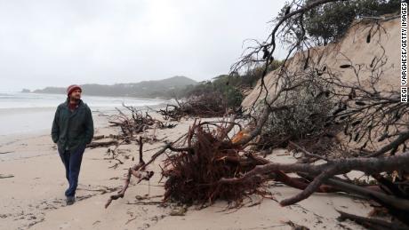 BYRON BAY, AUSTRALIA - DECEMBER 14:  Local resident Nick Colby checks the damage due to erosion along the beach side, December 14, 2020 in Byron Bay, Australia. Byron Bay&#39;s beaches face further erosion as wild weather and hazardous swells lash the northern NSW coastlines. (Photo by Regi Varghese/Getty Images)