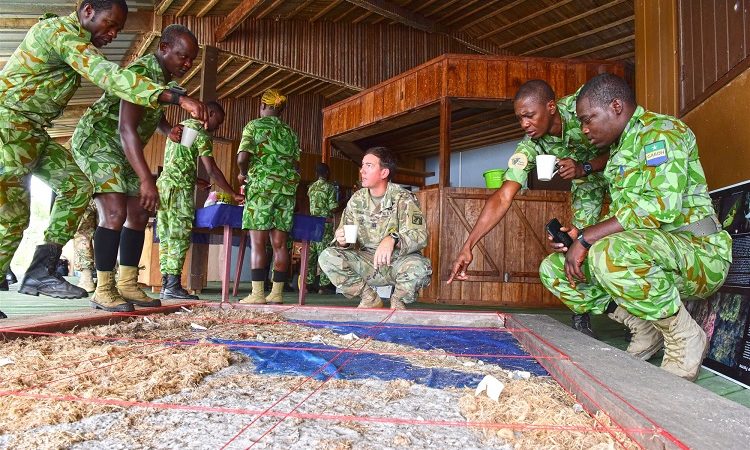 Team members from the U.S. Army Civil Affairs Team 8324,83rd Civil Affairs Battalion, receives an orientation on the terrain model provides guidance from the Eco-Guards in Loango National Park, Gabon
