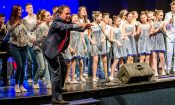 A man and group of girls on stage