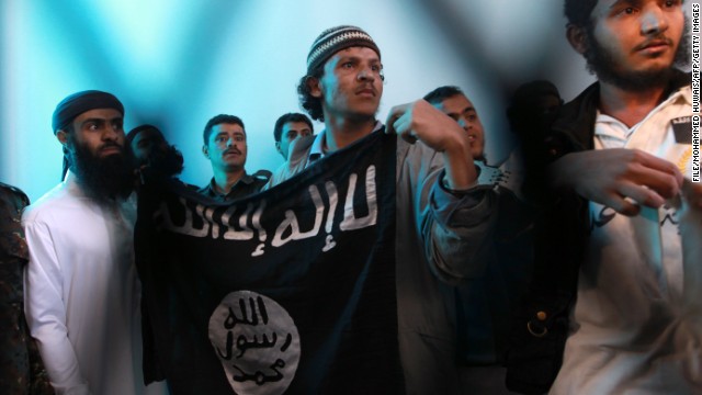 Yemeni al Qaeda militants hold a black al Qaeda flag.