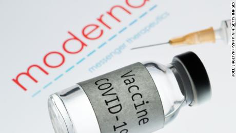 This picture taken on November 18, 2020 shows a syringe and a bottle reading &quot;Vaccine Covid-19&quot; next to the Moderna biotech company logo. - The CEO of Moderna warned European countries on November 17 that dragging out negotiations to purchase its promising new Covid-19 vaccine will slow down deliveries, as other nations that have signed deals will get priority. The biotech company Pfizer said the day after that a completed study of its experimental Covid-19 vaccine showed it is 95 percent effective, after Moderna said its own vaccine was 94.5 percent effective, according to a preliminary analysis. (Photo by JOEL SAGET / AFP) / -- IMAGE RESTRICTED TO EDITORIAL USE - STRICTLY NO COMMERCIAL USE -- (Photo by JOEL SAGET/AFP via Getty Images)