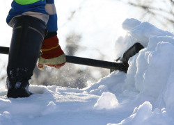 A worker shovels snow