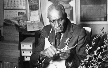 Portrait of George Washington Carver at work at Tuskegee University, Alabama