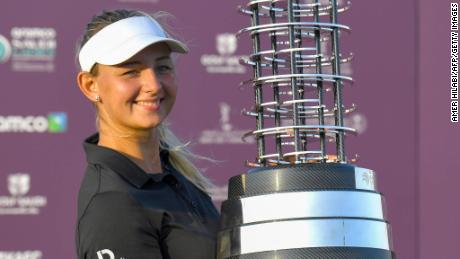 Danish golfer Emily Kristine Pedersen celebrates with the trophy after winning the Saudi Ladies International golf tournament on November 15, 2020, at the King Abdullah Economic City, north of Jeddah. (Photo by Amer HILABI / AFP) (Photo by AMER HILABI/AFP via Getty Images)