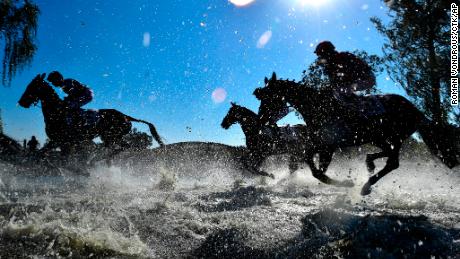 Horses and jockeys compete during the Steeplechase cross country in Pardubice, Czech Republic, October 14, 2018. 