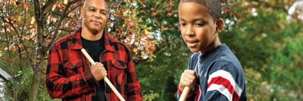 Picture of a father and son raking leaves