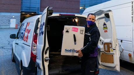 A FedEx driver delivers a box containing the Pfizer-BioNTech COVID-19 vaccine to Rhode Island Hospital in Providence, R.I., Monday, Dec. 14, 2020. (AP Photo/David Goldman)