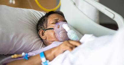 Patient in hospital bed on a ventilator