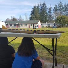 Photograph of students on a field at camp w ith test rockets