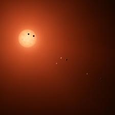 illustration shows the seven TRAPPIST-1 planets as they might look as viewed from Earth using a fictional, incredibly powerful telescope