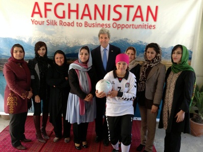 Secretary Kerry poses for a group photo during a tour of local businesses in Kabul, Afghanistan.