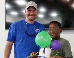 A big and little brother proudly display their successful Mars Lander