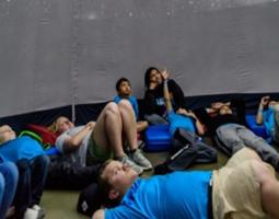 Children looking up in a planetarium.