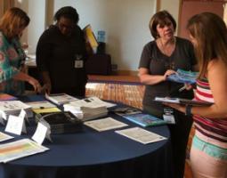 Tina Harte and three other women standing around a table with handouts