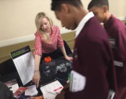 Dr. Kimberly Arcand shows 8th graders her exhibit