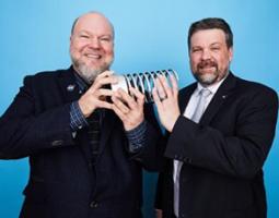 Two men holding a Webby award.