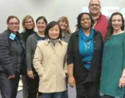 A group of smiling women and men