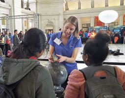 Andrea Jones shows a rock to two students.