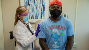 Man being injected with vaccine.