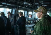 Woman in uniform watching from ship's bridge (U.S. Navy/Mass Communication Specialist 1st Class Benjamin K. Kittleson)