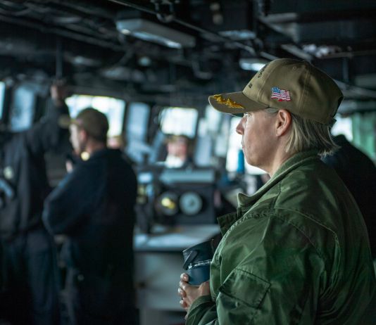 Amy Bauernschmidt in uniform watching from ship's bridge (U.S. Navy/Mass Communication Specialist 1st Class Benjamin K. Kittleson)