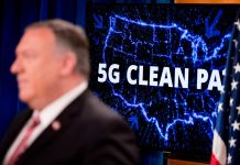 Mike Pompeo standing in front of illuminated map of the United States with words 5G Clean Path written on it (© Andrew Harnik/AP Images)