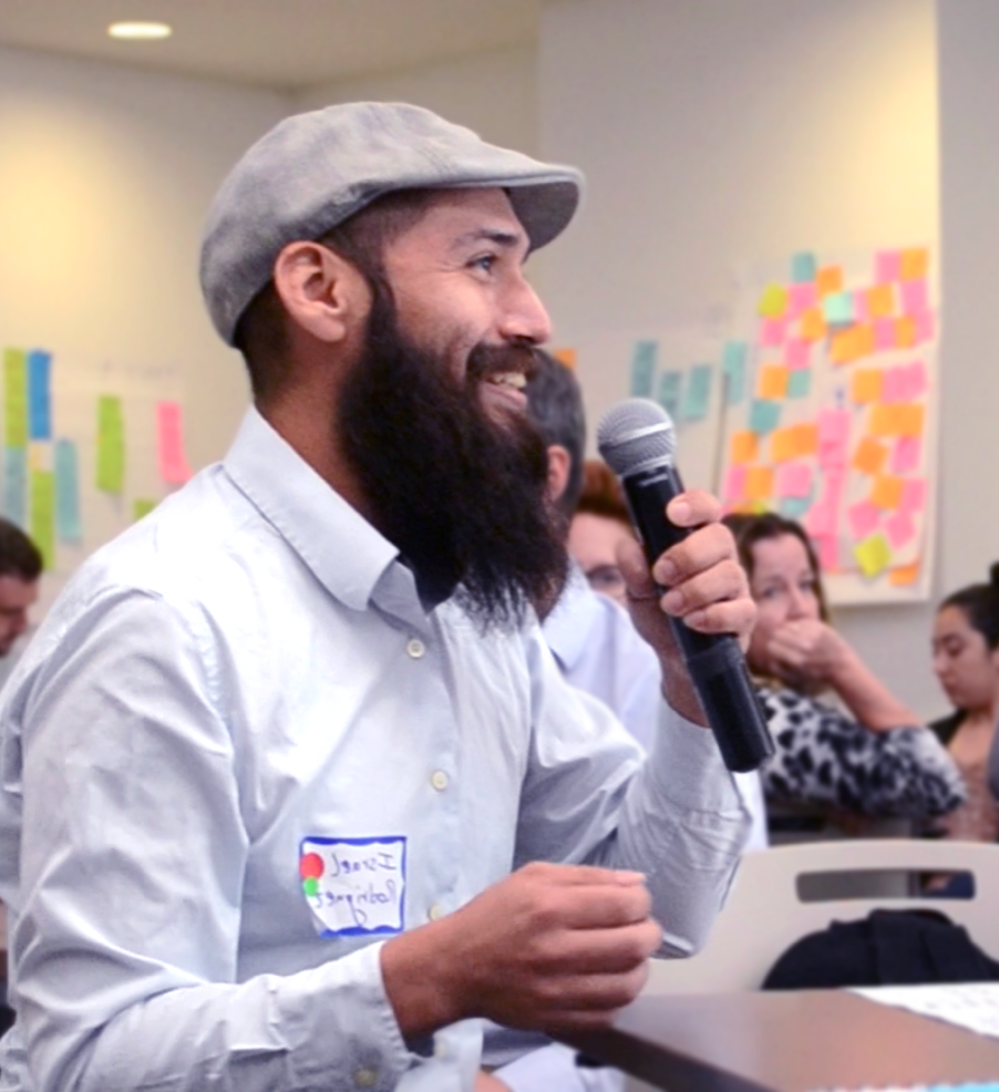 Man speaking into microphone at a user engagement workshop hosted by The Opportunity Project