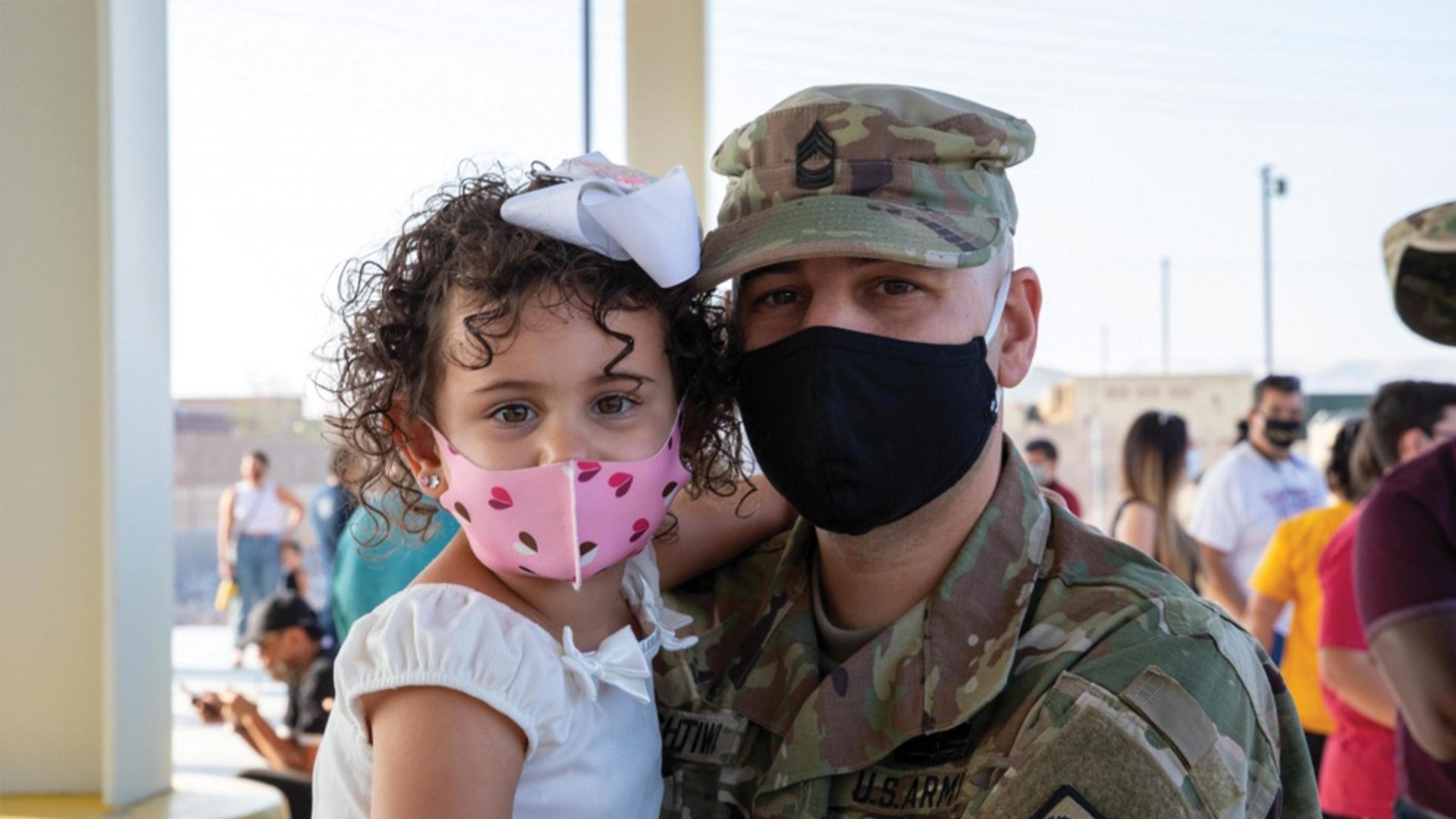 A service member and his daughter wear masksSource: https://www.dvidshub.net/image/6360257/mobilization-ceremony-bravo-company-with-422nd-expeditionary-signal-battalion