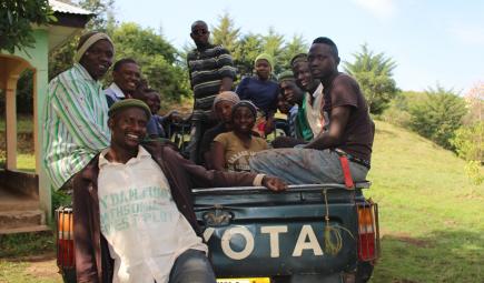 Workers at the Ngel Nyaki plot pose in back of pickup truck