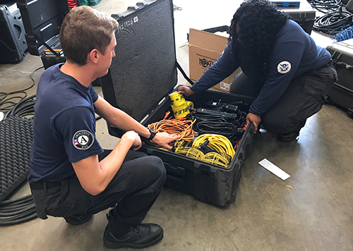 AmeriCorps NCCC team loading disaster materials into container