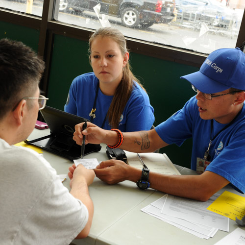 FEMA Corps members supporting an affected citizen