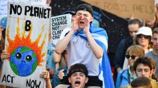 Protesters march and hold placards as they attend the Global Climate Strike on September 20, 2019 in Edinburgh