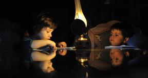 High peak demand for energy in FYR Macedonia can result in power outages around the country. Here a young child does homework by lamplight in a home outside of Skopje. Photo: Tomislav Georgiev / World Bank