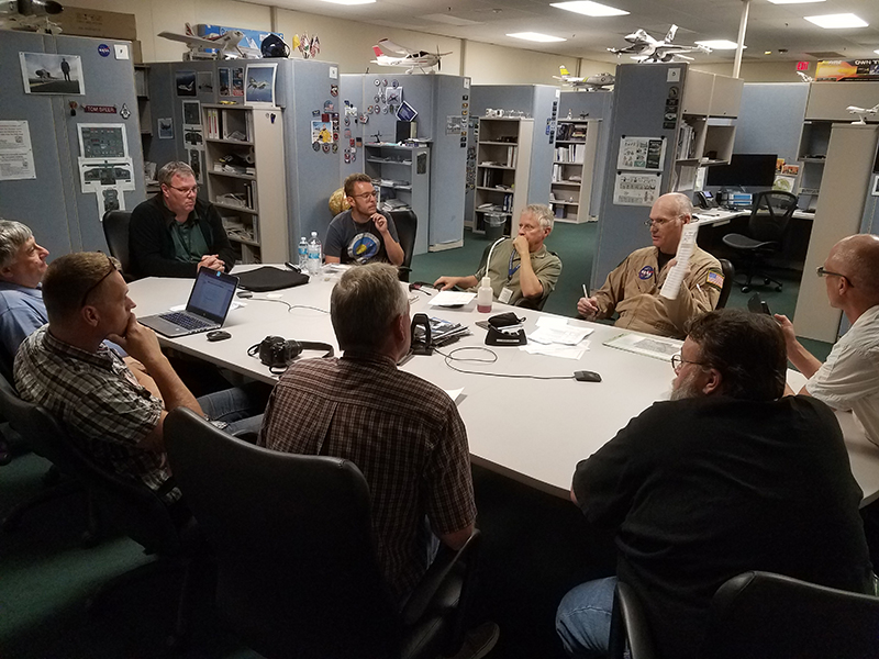 The ACEPOL team attends a briefing prior to the flight