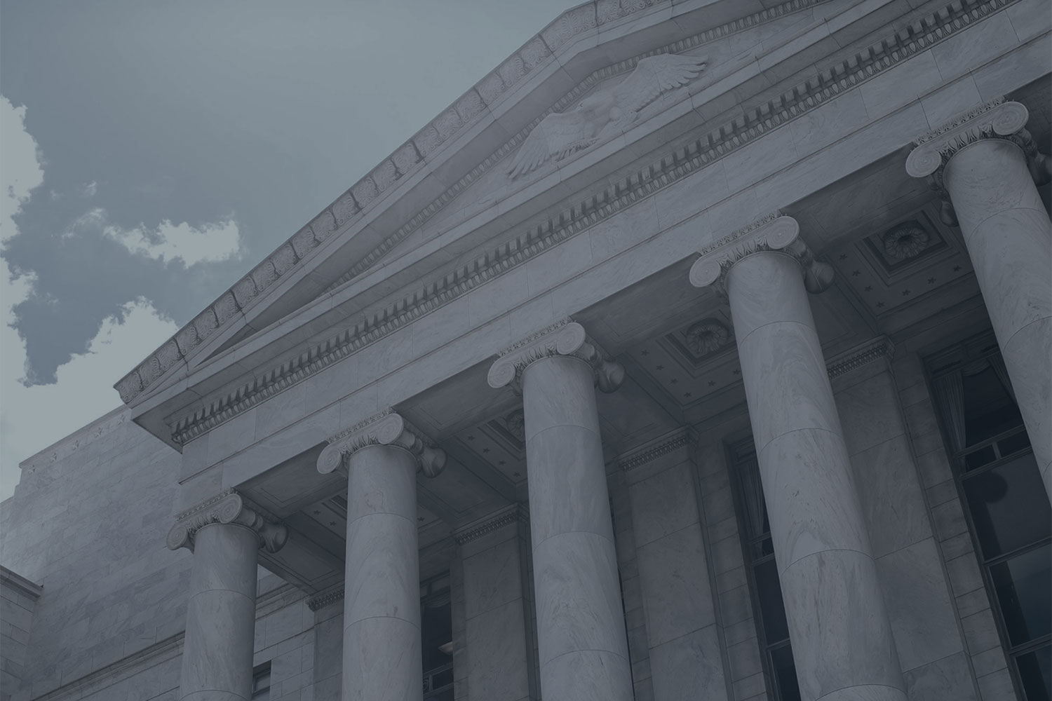 Marble columns and the top of a federal building