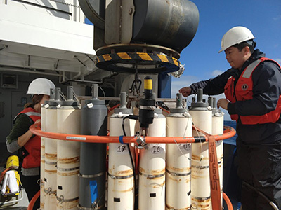 Scientist Yuanheng Xion (UND) readies Niskin bottles before a CTD is cast in the Gulf of Alaska. Credit: Abigale Wyatt (Princeton University)