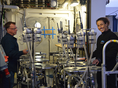 Steve Pike and Claudia Benitez-Nelson prepare filtration pumps for deployment. Samples are collected at specific depths and analyzed for microbial activity, pigments, and carbon soon after collection to minimize particle decay. Credit: Montserrat Roca Marti