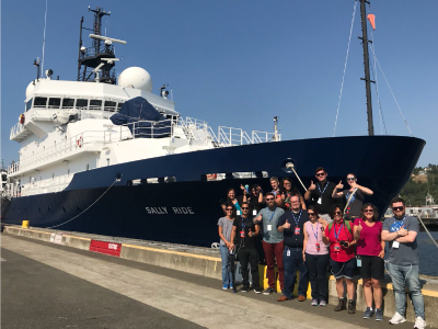 Participants from a NASA social media event pose by the R/V <em>Sally Ride</em> before it embarks on its August 2018 tour of the North Pacific. Credit: NASA