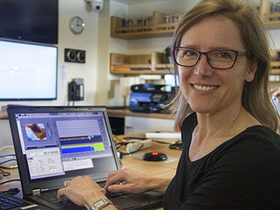 Stephanie Schollaert Uz monitors the speed and direction of water flowing under the ship with an Acoustic Doppler Current Profiler (ADCP). Credit: SOI