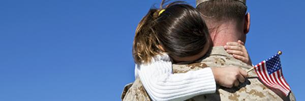 Marine hugging little girl 