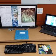 desk with laptop, scanner, mouse, keyboard, and monitor
